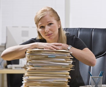 Women holding a stack of files
