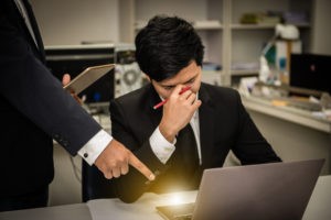 Man at a computer looking frustrated