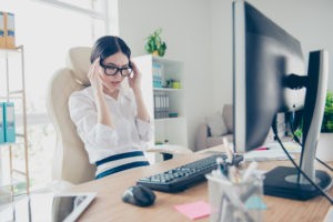 Young asian women at work struggling with regular migraines
