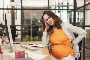 pregnant woman at work experiencing some distress