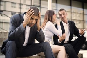 A person of color experiencing microaggressions in the workplace
