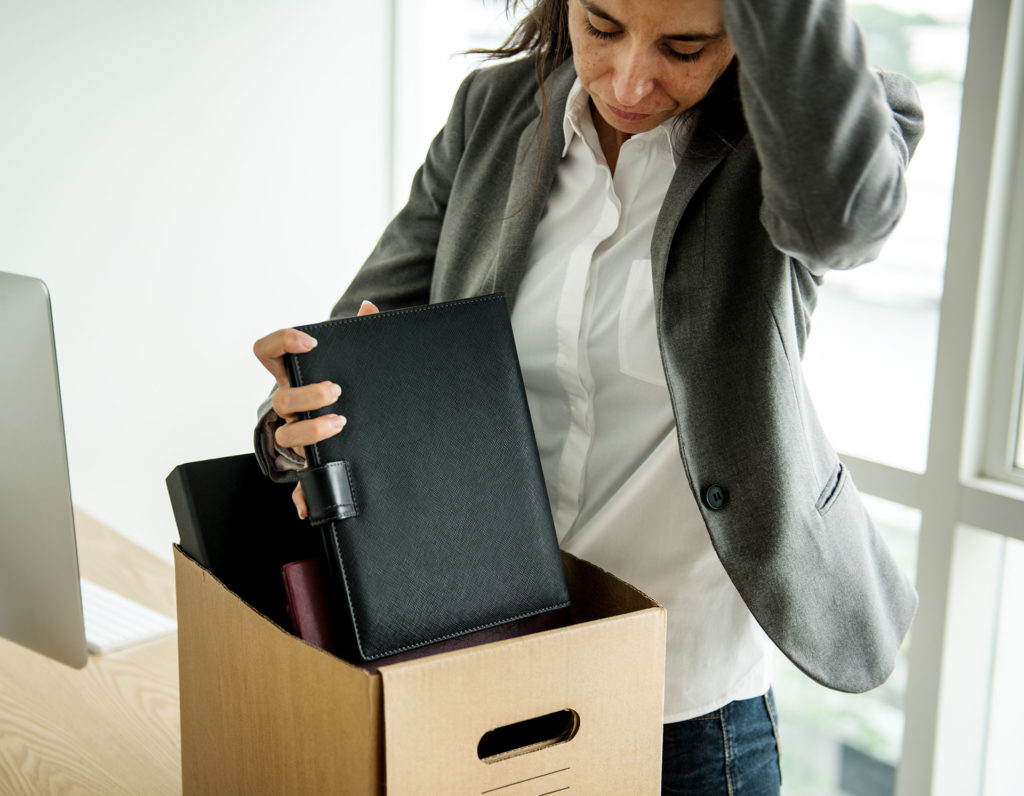 Fired woman packing up stuff